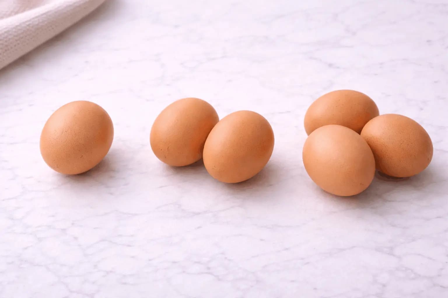 Multiple eggs arranged showing quantity representing the question of how many eggs to eat per day